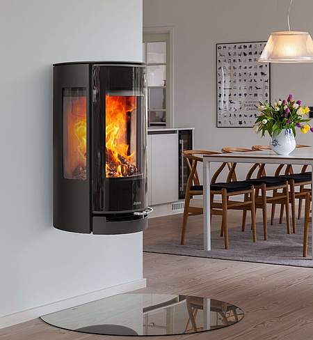 Wall-mounted stove with large glass door
